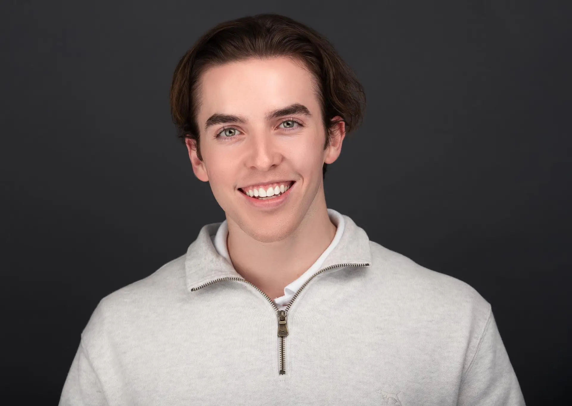 Actor headshot Sydney, smiling young man in grey jumper