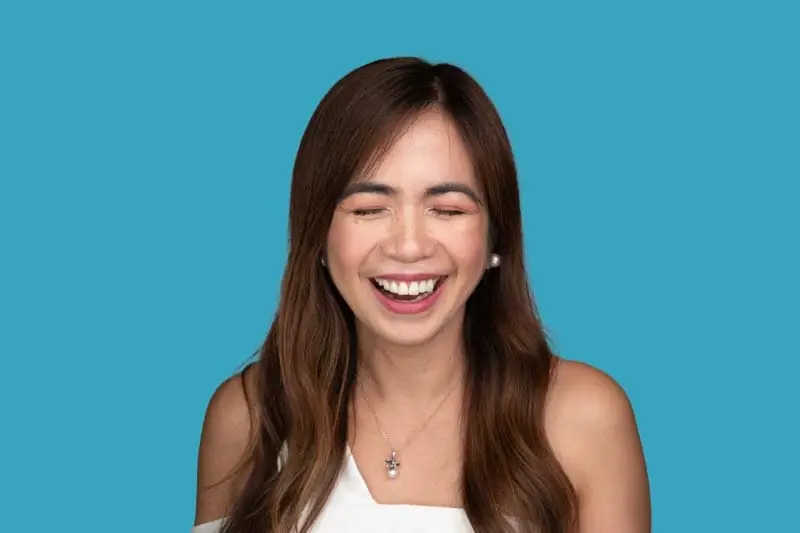 Actor headshot Sydney, laughing woman on blue background